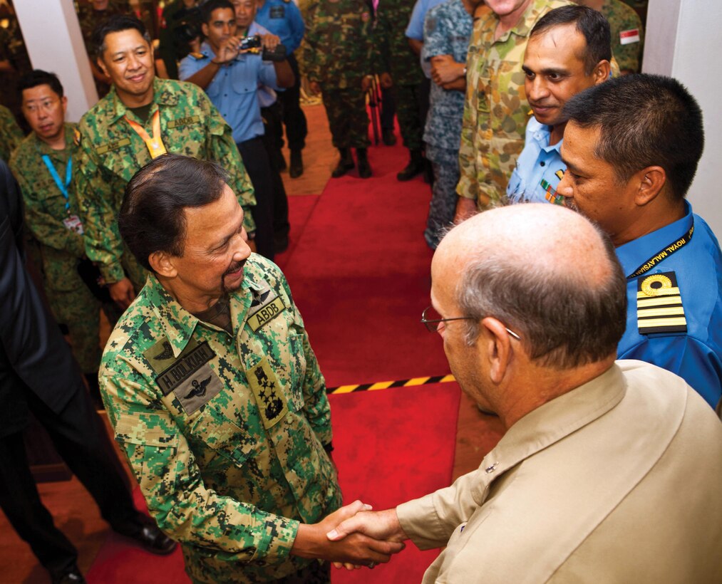 The sultan of Brunei, Hassanal Bolkiah, greets U.S. Merchant Marine Capt. William Baldwin at the warrant officers mess June 20 in Muara, Brunei, during the Association of Southeast Asian Nations Defence Ministers Meeting– Plus ASEAN Humanitarian Assistance/Disaster Relief and Military Medicine Exercise. Bolkiah made a final tour of the exercise sites and concluded the exercise at a luncheon with other military leaders. Baldwin is the USNS Matthew Perry ship's master. 