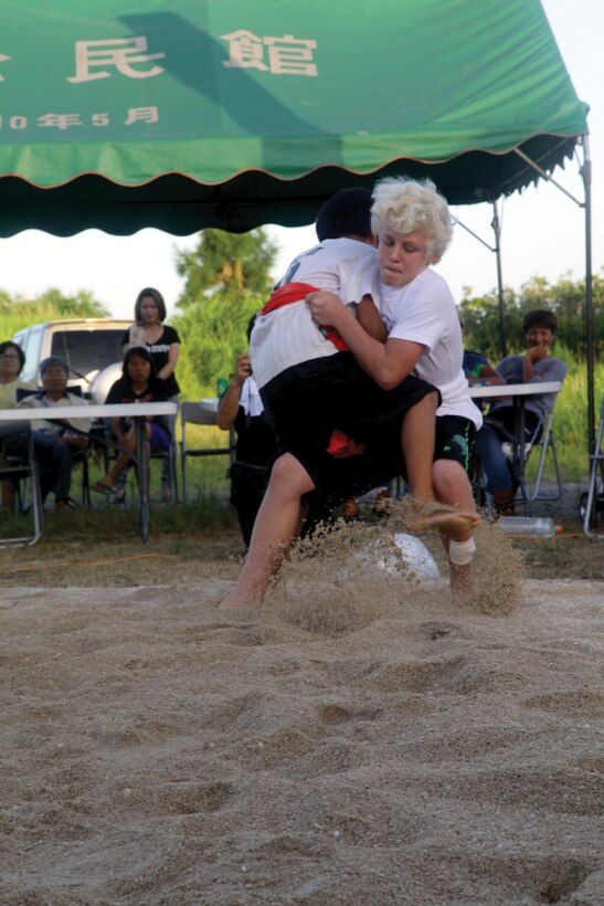 Riley Inns, right, battles his opponent at the Henoko Okinawa-Style Sumo Tournament June 22 at the Mae-No-Hama Field. Inns went on to defeat two more opponents to win first place in the children’s age tournament, according to Fumio Iha, community relations specialist for Camp Schwab. Inns, 13, is the son of a Marine. 
