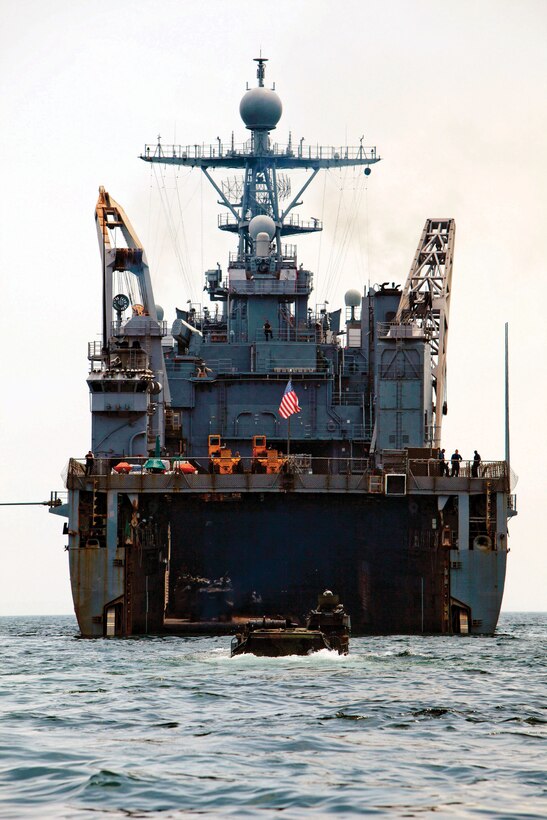Marines with Combat Assault Battalion, 3rd Marine Division, III Marine Expeditionary Force, return to the amphibious dock landing ship USS Tortuga after conducting amphibious assault training with the Malaysian Armed Forces during Cooperation Afloat Readiness and Training 2013 in Malaysia. 