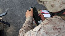 A Marine with Transportation and Support Company, Combat Logistics Battalion 2, 2nd Marine Logistics Group performs a proper NATO format 9-line casualty evacuation during a fire team challenge aboard Camp Lejeune, N.C., June 27, 2013. Service members carried a casualty in a collapsible stretcher, turned on and loaded a PRC-152 radio, and called in a simulated casualty evacuation during one of the six fire team challenges.