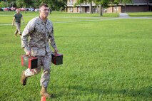 A Marine with Transportation and Support Company, Combat Logistics Battalion 2, 2nd Marine Logistics Group runs with ammunition cans during a small portion of the Marine Corps Combat Fitness Test during a fire team challenge aboard Camp Lejeune, N.C., June 27, 2013. Marines with the unit had to compete against each other in six different stations. 