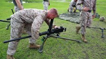 A Marine with Transportation and Support Company, Combat Logistics Battalion 2, 2nd Marine Logistics attaches a barrel to a .50-caliber machine gun during a fire team challenge aboard Camp Lejeune, N.C., June 27, 2013. Marines with the unit had to ensure the proper headspace and timing of a .50-caliber machine gun and assemble and disassemble a M-240B medium machine gun during one of the six challenges.