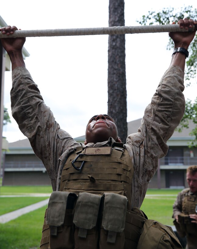 A Marine with Transportation and Support Company, Combat Logistics Battalion 2, 2nd Marine Logistics Group attempts to do a pull-up during a fire team challenge aboard Camp Lejeune, N.C., June 27, 2013. Marines with the unit competed against each other to receive a meritorious mast from the company commander.