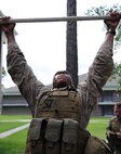 A Marine with Transportation and Support Company, Combat Logistics Battalion 2, 2nd Marine Logistics Group attempts to do a pull-up during a fire team challenge aboard Camp Lejeune, N.C., June 27, 2013. Marines with the unit competed against each other to receive a meritorious mast from the company commander.