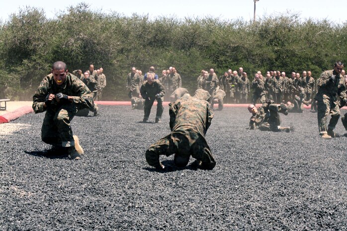 Recruits with Company I, 3rd Recruit Training Battalion, execute forward shoulder rolls during the Break Falls and Leg Sweep class aboard Marine Corps Recruit Depot San Diego June 10.  
