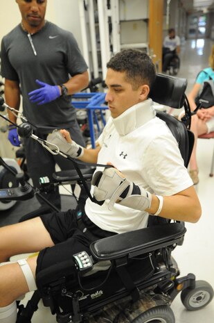 2nd Lt. John Bobrousiecki, patient, Spinal Cord Injury and Disorders Center of Excellence, pulls weights during his kinesiotherapy session at the Hunter Holmes VA Medical Center on June 30, 2013. Bobrousiecki also receives therapeutic services in activities for daily living.