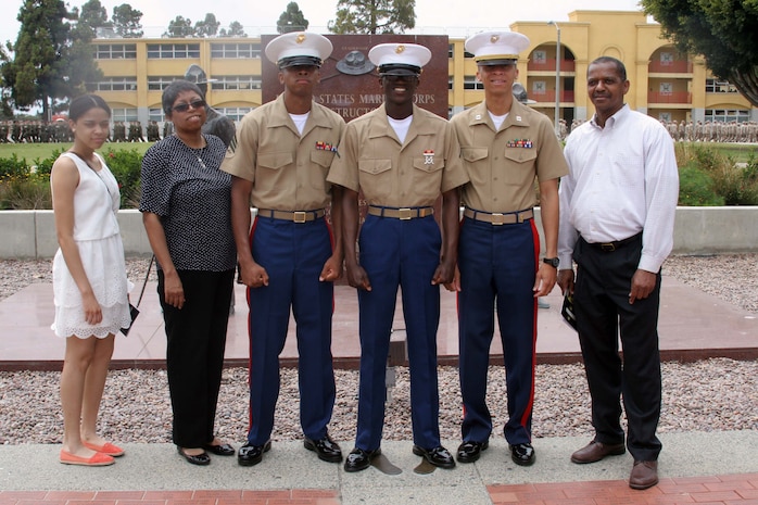 Pfc. Marcus J. Hamilton Platoon 2145, Company G, 2nd Recruit Training Battalion, stands in front of the drill instructor monument with his family after graduation aboard Marine Corps Recruit Depot June 14.