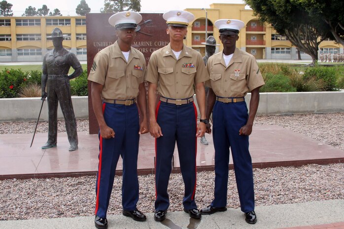 Pfc. Marcus J. Hamilton Platoon 2145, Company G, 2nd Recruit Training Battalion, and his two brothers, captain and sergeant Hamilton, stand together after graduation aboard Marine Corps Recruit Depot San Diego June 14.