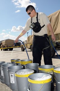 Staff Sgt. Roberto Caceres, decontamination noncommissioned officer, 92nd Civil Support Team, Nevada National Guard, prepares a decontamination site during the 92nd CST’s evaluation exercise Feb. 10 at the National Guard Readiness Center in Las Vegas.
