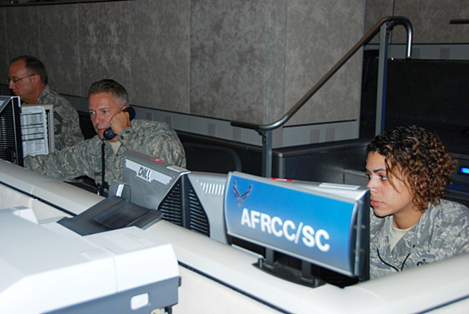 Search and rescue coordinators Major Bill Kennedy and Staff Sergeant Diane Brown monitor ongoing search and rescue operations.  The Air
Force Rescue Coordination Center serves as the single agency responsible for coordinating life saving federal search and rescue services. 