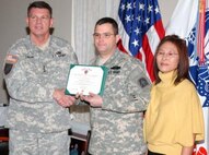 Lt. Gen. Guy Swan III, commanding general, U.S. Army North, presents the Purple Heart award to Sgt. Maj. Daniel Adle during a ceremony Jan. 8 at the Army North headquarters. Adle, while serving with the 1st Cavalry Division, was injured in Iraq’s Diyala Province on April 7, 2007 during a complex attack by terrorists using small-arms fire, grenades and improvised-explosive devices. Following the presentation of his award, Adle thanked his wife, Kum Yo Adle, for taking care of him as he went through his recovery process as well as for her support throughout the years.
