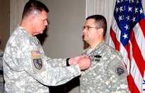 Lt. Gen. Guy Swan III (left), commanding general, U.S. Army North, presents the Purple Heart award to Sgt. Maj. Daniel Adle during a ceremony Jan. 8 at the Army North headquarters. Adle, while serving with the 1st Cavalry Division, was injured in Iraq’s Diyala Province on April 7, 2007 during a complex attack by terrorists using small-arms fire, grenades and improvised-explosive devices.