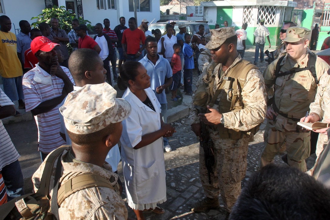 Marines and Sailors from the 24th Marine Expeditionary Unit and the Nassau Amphibious Ready Group conduct an assessment of St Marc, Haiti. These Marines and Sailors handed out Meals Ready to Eat and bottled water to the patients at the St Nicholas Hospital in St Marc. 