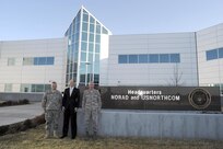 Mr. David Heyman (center), Assistant Secretary for Policy for the Department of Homeland Security, poses for a photo with Army Brig. Gen. Bob Felderman (left) and Air Force Maj. Gen. John Bordelon (right) in front of the North American Aerospace Defense Command and U.S. Northern Command Headquarters at Peterson Air Force Base, Colo., Apr. 13. Mr. Heyman visited the commands to become familiar with the missions and to specifically discuss air domain awareness and the Quadrennial Defense Review and Quadrennial Homeland Security Review. 
