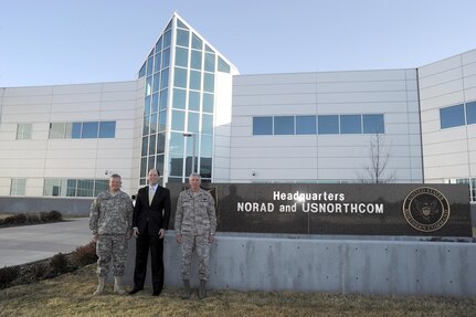 Mr. David Heyman (center), Assistant Secretary for Policy for the Department of Homeland Security, poses for a photo with Army Brig. Gen. Bob Felderman (left) and Air Force Maj. Gen. John Bordelon (right) in front of the North American Aerospace Defense Command and U.S. Northern Command Headquarters at Peterson Air Force Base, Colo., Apr. 13. Mr. Heyman visited the commands to become familiar with the missions and to specifically discuss air domain awareness and the Quadrennial Defense Review and Quadrennial Homeland Security Review. 