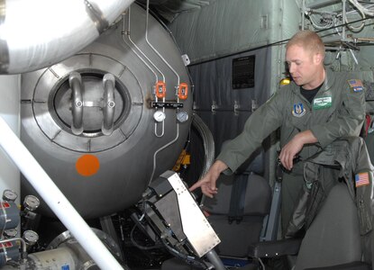 Air Force Master Sgt. Lamont Wood, 731st Airlift Squadron loadmaster, points out the control system for the Modular Airborne Firefighting System to members of the media after a successful test of the system April 22. The MAFFS II system was tested in preparation for a week-long certification event in which the 302nd Airlift Wing will participate in Greenville, S.C., April 26. 