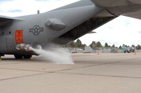 Members of the 302nd Airlift Wing begin a wet fire test of the Modular Airborne Firefighting System II April 22. Air crew members test the system using water, but when operational, firefighters have several different types of fire retardant at their disposal. Carried in the cargo area of a C-130, the MAFFS II is capable of dispersing fire retardant in a quarter-mile long, 100 ft. wide swath from 150 feet in the air, creating fire breaks to protect communities in the path of forest fires. During periods of high wildfire activity, MAFFS-trained military units such as the 302nd, are available under command of U.S. Northern Command to supplement other fire-fighting aircraft. 