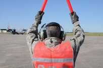 Aircrews from the 146th Air Expeditionary Group (part of a unified military support effort of U.S. Northern Command to provide assistance to the U.S. Forest Service, state and local agencies, and the National Interagency Fire Center in battling large, uncontrolled wildfires throughout the nation) work with Air traffic controllers, lead pilots and maintenance crews to deliver retardant to fire-damaged areas.  Here, Master Sgt. Shawn Crisco marshals in aircraft MAFFS eight for servicing and reload in Greenville, SC. 