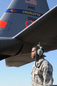 Aircrews from the 146th Air Expeditionary Group (part of a unified military support effort of U.S. Northern Command to provide assistance to the U.S. Forest Service, state and local agencies, and the National Interagency Fire Center in battling large, uncontrolled wildfires throughout the nation) work with Air traffic controllers, lead pilots and maintenance crews to deliver retardant to fire-damaged areas.  Here, Staff Sgt. Evait Hayes, an avionics technician with the N.C. Air National Guard, anticipates to jump into action as aircraft MAFFS eight parks for servicing and reload in Greenville, SC. 