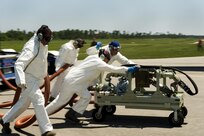 A team of U.S. Air Force aerial spray aircraft maintainers from the 910th Aircraft Maintenance Squadron move a chemical pump into position to refill a chemical dispersing C-130 Hercules cargo aircraft at Stennis International Airport in Kiln, Miss., on May 4, 2010.  Members of the 910th Airlift Wing are in Mississippi to assist with response to the Deepwater Horizon oil spill.  The 910th AW specializes in aerial spray and is the Department of Defense's only large-area, fixed-wing aerial spray unit. 