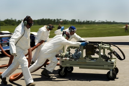 A team of U.S. Air Force aerial spray aircraft maintainers from the 910th Aircraft Maintenance Squadron move a chemical pump into position to refill a chemical dispersing C-130 Hercules cargo aircraft at Stennis International Airport in Kiln, Miss., on May 4, 2010.  Members of the 910th Airlift Wing are in Mississippi to assist with response to the Deepwater Horizon oil spill.  The 910th AW specializes in aerial spray and is the Department of Defense's only large-area, fixed-wing aerial spray unit. 