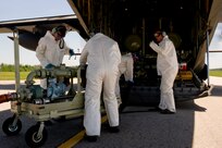 A team of U.S. Air Force aerial spray aircraft maintainers from the 910th Aircraft Maintenance Squadron  at Youngstown-Warren Air Reserve Station, Ohio, refill a chemical dispersing C-130 Hercules aircraft at Stennis International Airport in Kiln, Miss., May 4, 2010. Members of the 910th Airlift Wing (AW) are in Mississippi to assist with the Deepwater Horizon oil spill. The 910th AW specializes in aerial spray and is the Department of Defense's only large-area fixed-wing aerial spray unit.