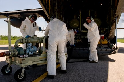 A team of U.S. Air Force aerial spray aircraft maintainers from the 910th Aircraft Maintenance Squadron  at Youngstown-Warren Air Reserve Station, Ohio, refill a chemical dispersing C-130 Hercules aircraft at Stennis International Airport in Kiln, Miss., May 4, 2010. Members of the 910th Airlift Wing (AW) are in Mississippi to assist with the Deepwater Horizon oil spill. The 910th AW specializes in aerial spray and is the Department of Defense's only large-area fixed-wing aerial spray unit.