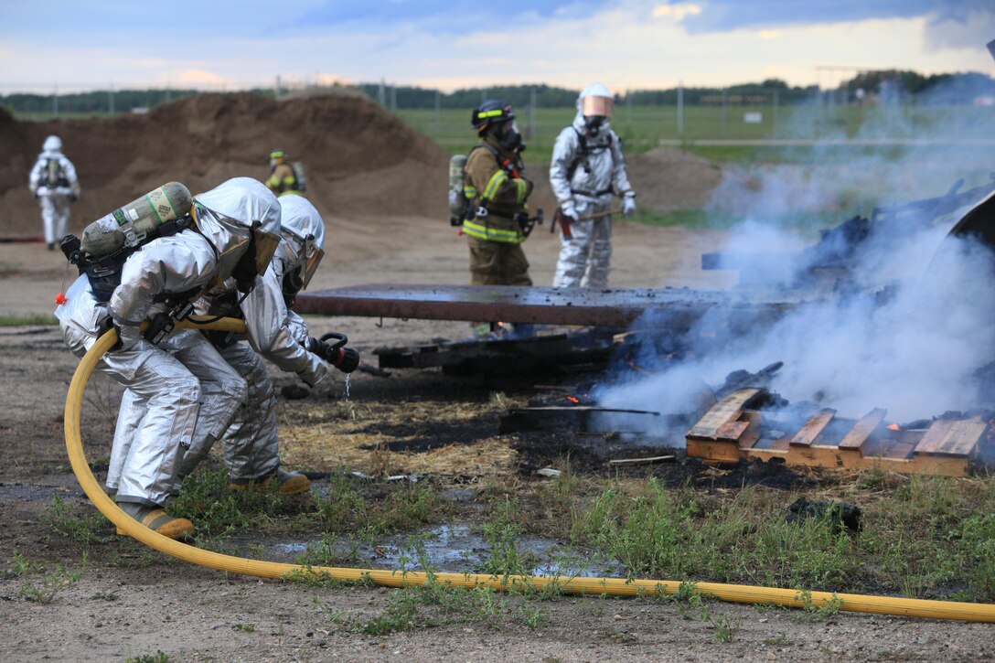 COLD LAKE, Alberta – Lance Cpls Aaron Greenlee, Cameron Gasaway and Ross Merritt await commands during an aircraft fire training simulation during multinational exercise Maple Flag here, June 12. (U.S. Marine Corps photo by Lance Cpl. Tiffany Edwards)