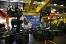 Two vehicles hold a welcome home banner during a homecoming event at Camp Lejeune, N.C., for Combat Logistics Regiment 2, 2nd Marine Logistics Group, July 1, 2013. Service members returned from a six month deployment to Afghanistan in support of Operation Enduring Freedom.  (U.S. Marine Corps photo by Lance Cpl. Shawn Valosin)