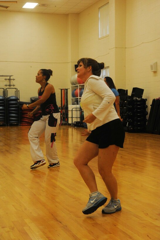 Women participate in a workout routine during a Zumba toning class at the Barber Physical Activities Center aboard Marine Corps Base Quantico on July 2, 2013. The class implements various dance moves and music to burn calories.