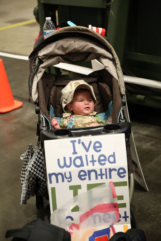 The infant of a service member met his dad for the first time during a homecoming for Combat Logistics Regiment 2, 2nd Marine Logistics Group, aboard Camp Lejeune, N.C., July 1, 2013. He was one of many children at the homecoming waiting to meet their daddy. (U.S. Marine Corps photo by Lance Cpl. Shawn Valosin)