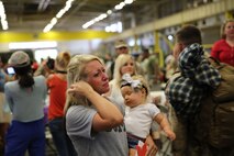 Emotions were high during a homecoming event for service members from Combat Logistics Regiment 2, 2nd Marine Logistics Group aboard Camp Lejeune, N.C., July 1, 2013. Family members hadn’t seen their loved ones in six months, during which time some had given birth and were anxious for their babies to meet their other parent. (U.S. Marine Corps photo by Lance Cpl. Shawn Valosin)