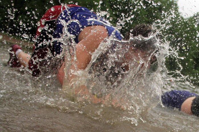 Woodbury High School Football Player Reid Peters crawls along the shoreline at Carver Lake during Recruiting Station Twin Cities' workout challenge June 21. Marines from Recruiting Substations Woodbury and Roseville ran the entire team through several exercise stations that focused on different muscle groups. For additional imagery from the event visit www.facebook.com/rstwincities.