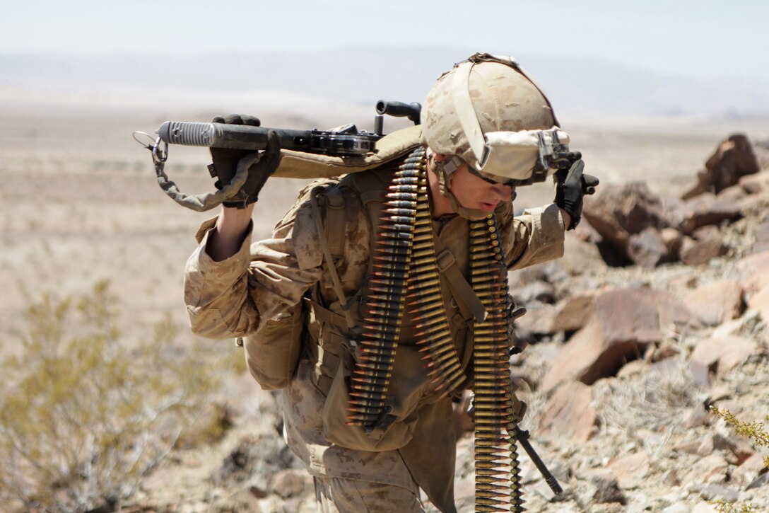 TWENTYNINE PALMS, Calif. – Pfc. Alex Kempf, a machine gunner with Company B, 1st Battalion, 24th Marine Regiment, and a native of Evansville, Ind., carries a M240B machine gun up a hill at Marine Corps Air-Ground Combat Center here, June 18. Range 410A allows Marines the opportunity to work on small-unit leadership by completing a series of obstacles that involve a platoon-sized element. Range 410A is part of Integrated Training Exercise 4-13, a cornerstone of the Marine Air-Ground Task Force Training Program. It is the largest annual U.S. Marine Corps Reserve training exercise. ITX 4-13, utilizing assets from ground, air and logistic combat elements is a live, virtual, constructive battalion exercise. (U.S. Marine Corps photo by Cpl. John M. McCall) 