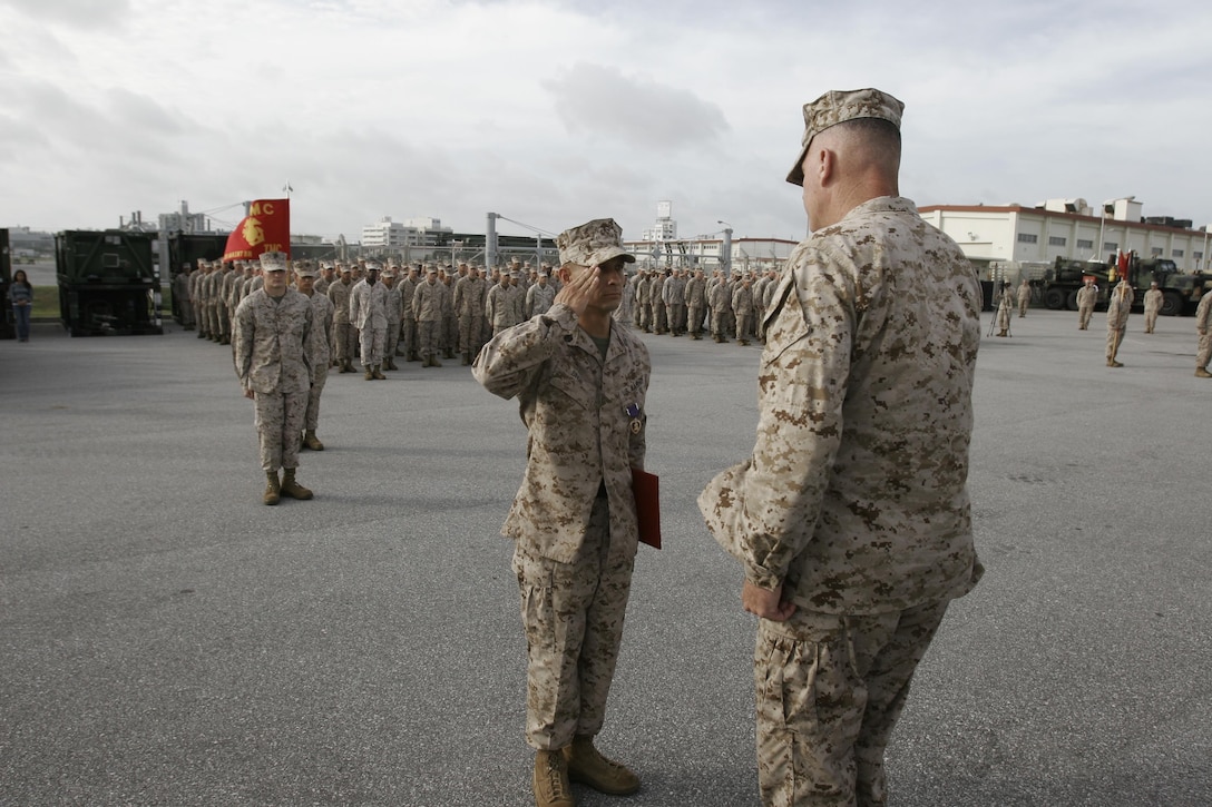 Staff Sgt. Nicholas Singh, left, salutes Brig. Gen. Niel E. Nelson during a ceremony June 27 on Camp Kinser. During the ceremony, Singh was awarded the Purple Heart medal for injuries sustained while supporting Operation Enduring Freedom in Afghanistan. Nelson is the commanding general of 3rd Marine Logistics Group, III Marine Expeditionary Force, and Singh is a maintenance chief with 3rd Maintenance Battalion, Combat Logistics Regiment 35, 3rd MLG, III MEF. (U.S. Marine Corps photo by Lance Cpl. Nicholas S. Ranum/Released)