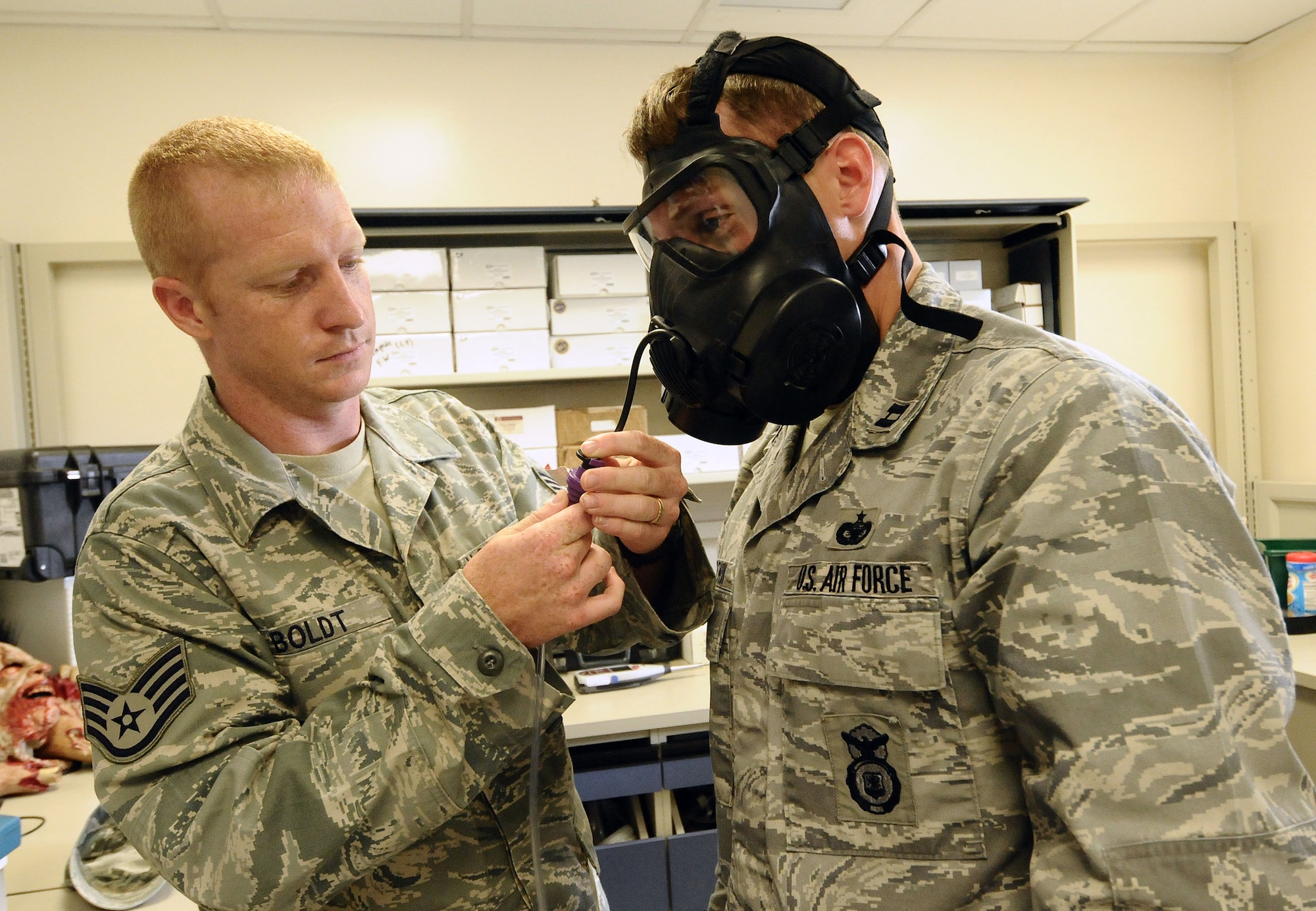 Staff Sgt. Jeremy Boldt, 36th Medical Operations Squadron Bioenvironmental Flight bioenvironmental engineering technician, administers a gas mask fit test to Capt. Dennis Trutwin, 736th Security Forces Squadron commander, on Andersen Air Force Base, Guam, July 2, 2013. The flight conducts approximately 100 of these evaluations per month to test how well a mask will protect its wearer from chemical or biological warfare agents in the event of an attack. (U.S. Air Force photo by Airman 1st Class Mariah Haddenham/Released)