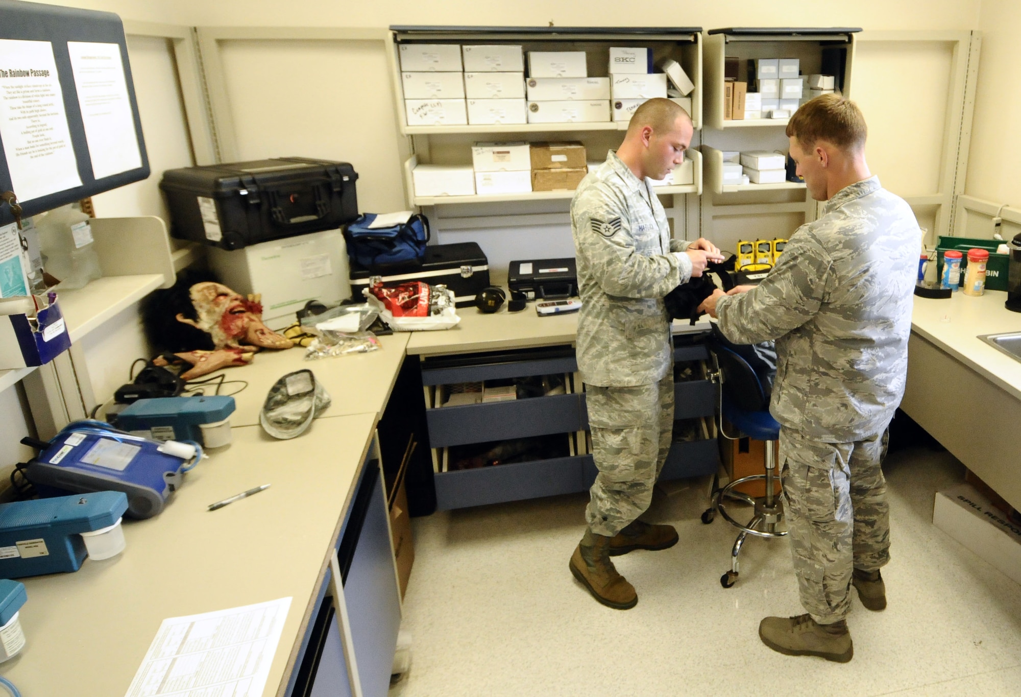 Staff Sgt. John Matlock, 36th Medical Operations Squadron Bioenvironmental Flight bioenvironmental engineering technician, helps Capt. Dennis Trutwin, 736th Security Forces Squadron commander, prepare for a gas mask fit test on Andersen Air Force Base, Guam, July 3, 2013. The flight conducts approximately 100 of these evaluations per month to test how well a mask will protect its wearer from chemical or biological warfare agents in the event of an attack. (U.S. Air Force photo by Airman 1st Class Mariah Haddenham/Released)
