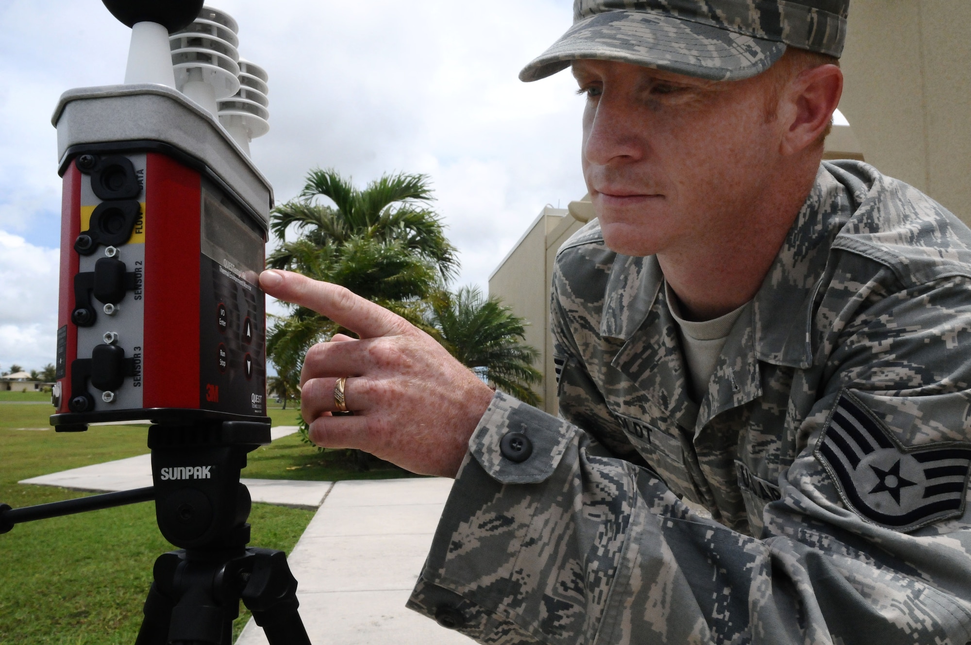 Staff Sgt. Jeremy Boldt, 36th Medical Operations Squadron Bioenvironmental Flight bioenvironmental engineering technician, checks the Wet-Bulb Globe Temperature reading on Andersen Air Force Base, Guam, July 2, 2013. Airmen from the bioenvironmental flight monitor the WBGT every two hours, which is a combined reading of radiant heat, ambient heat and humidity, to help determine the heat stress indicator level of the base. (U.S. Air Force photo by Airman 1st Class Mariah Haddenham/Released)
