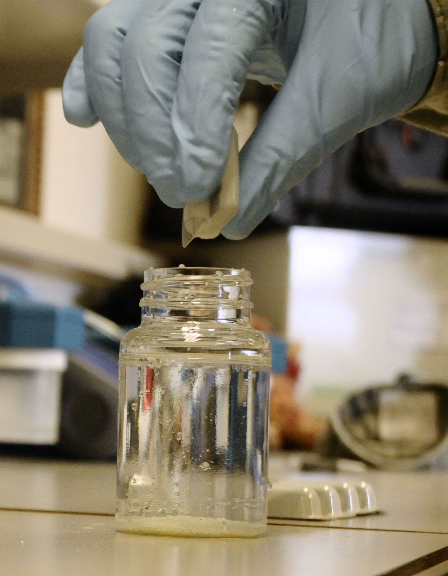 Staff Sgt. John Matlock, 36th Medical Operations Squadron Bioenvironmental Flight bioenvironmental engineering technician, tests a water sample for bacteria on Andersen Air Force Base, Guam, July 2, 2013. The flight takes monthly samples from various locations on base to ensure the water supply remains safe to use. (U.S. Air Force photo by Airman 1st Class Mariah Haddenham/Released)