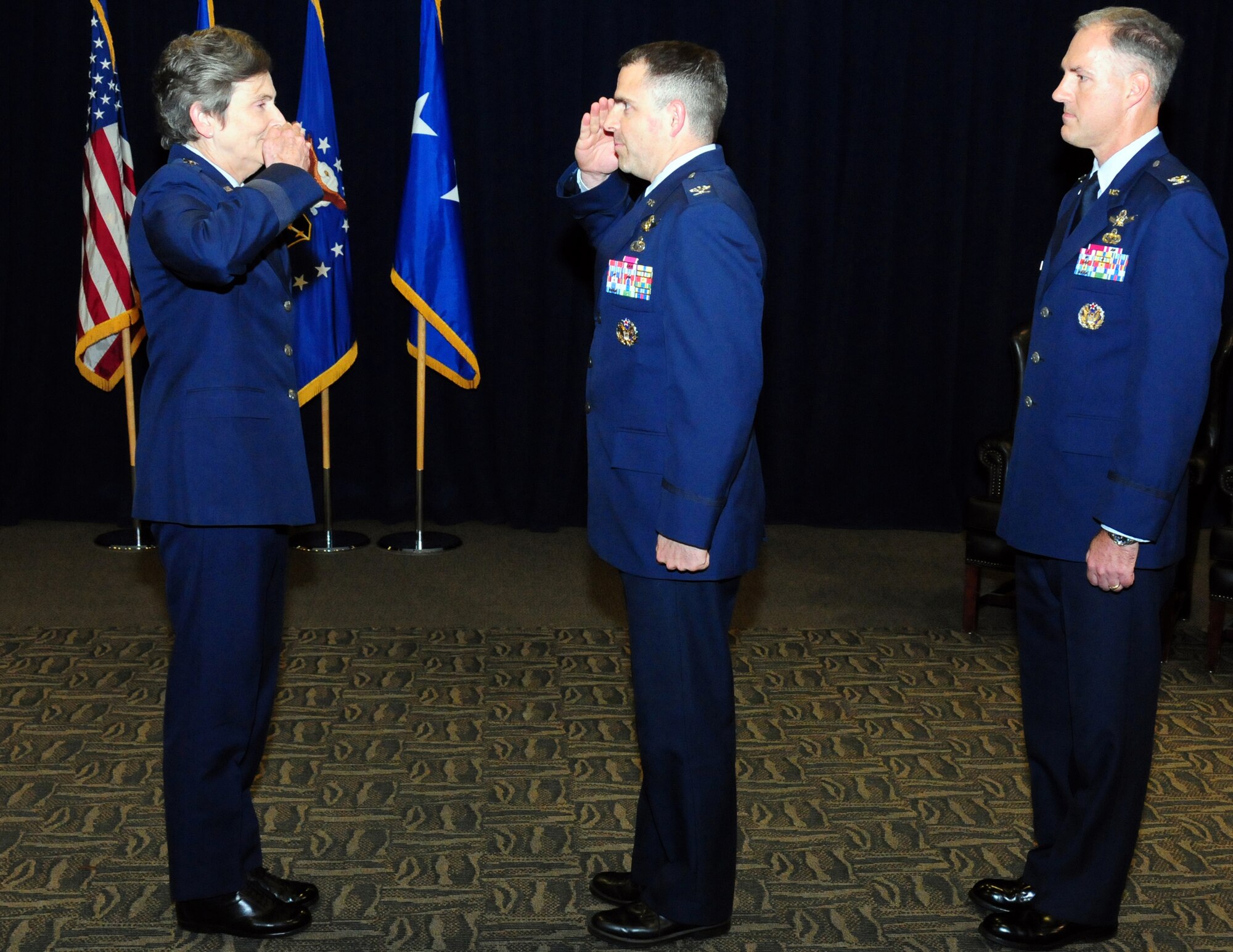 Colonel William Cooley assumes the leadership of the GPS Directorate from Col. Bernard Gruber at a change of leadership ceremony held here, June 13.  Pictured from left to right are Lt. Gen. Ellen Pawlikowski, SMC commander; Col. William Cooley, incoming GPS director; and Col. Bernard Gruber, outgoing director. (Photo by Jim Gordon)