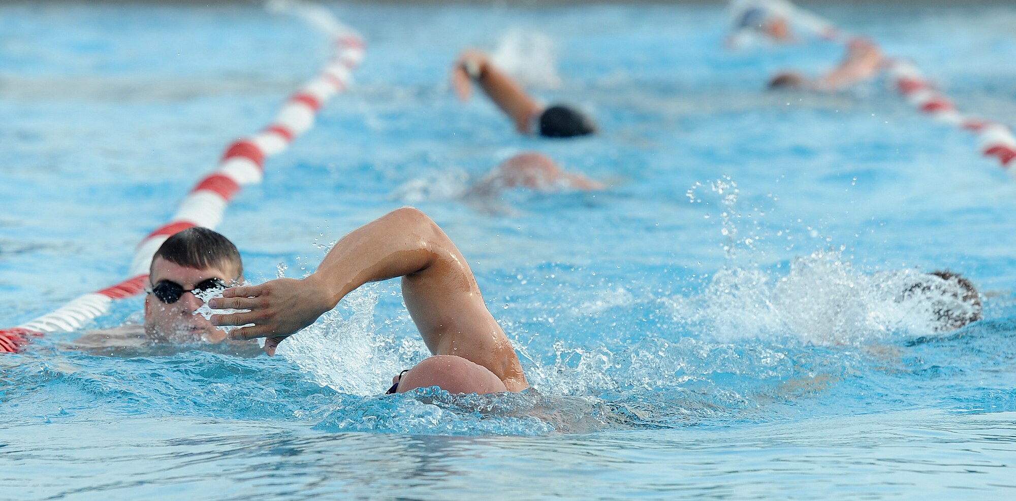 1st Lt. Kevin Knutson, 509th Logistics Readiness Squadron, competes in the 420-meter swim portion of a triathlon at Whiteman Air Force Base, Mo., June 21, 2013. Fitness center staff members hosted the annual triathlon to promote fitness and boost morale for Service members and their families. (U.S. Air Force photo by Staff Sgt. Nick Wilson/Released)