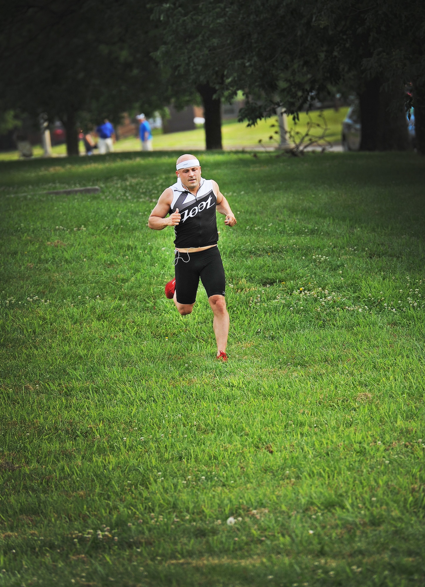 1st Lt. Kevin Knutson, 509th Logistics Readiness Squadron, runs a five-kilometer race as part of a triathlon at Whiteman Air Force Base, Mo., June 21, 2013. Out of 36 participants, Knutson finished the race in sixth place in 57 minutes and 13 seconds. (U.S. Air Force photo by Staff Sgt. Nick Wilson/Released)