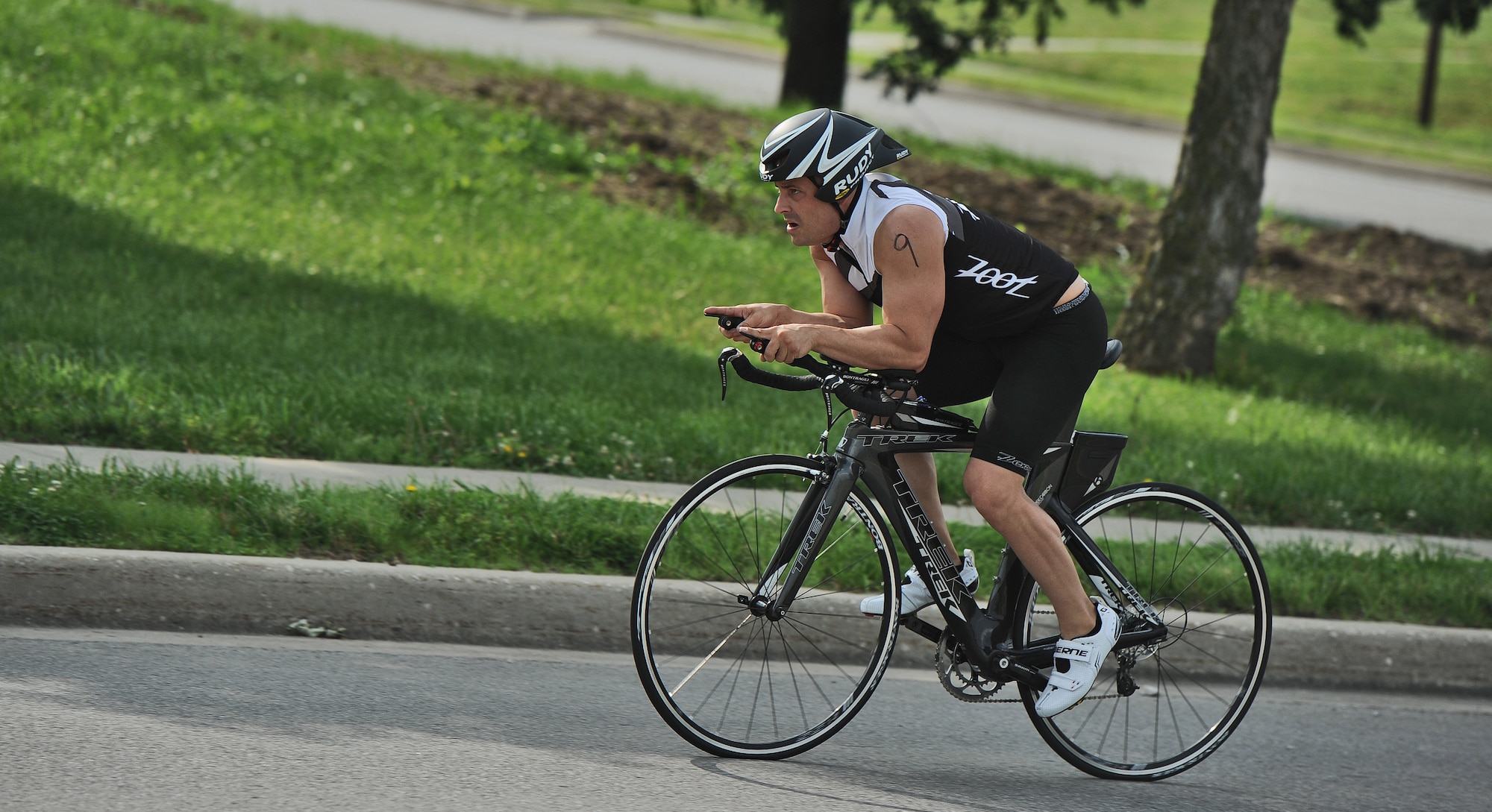 1st Lt. Kevin Knutson, 509th Logistics Readiness Squadron, completes the final stretch of a 10-kilometer bicycle race during a triathlon at Whiteman Air Force Base, Mo., June 21, 2013. This was Knutson’s first triathlon; he finished with a time of 57 minutes and 13 seconds. (U.S. Air Force photo by Staff Sgt. Nick Wilson/Released)