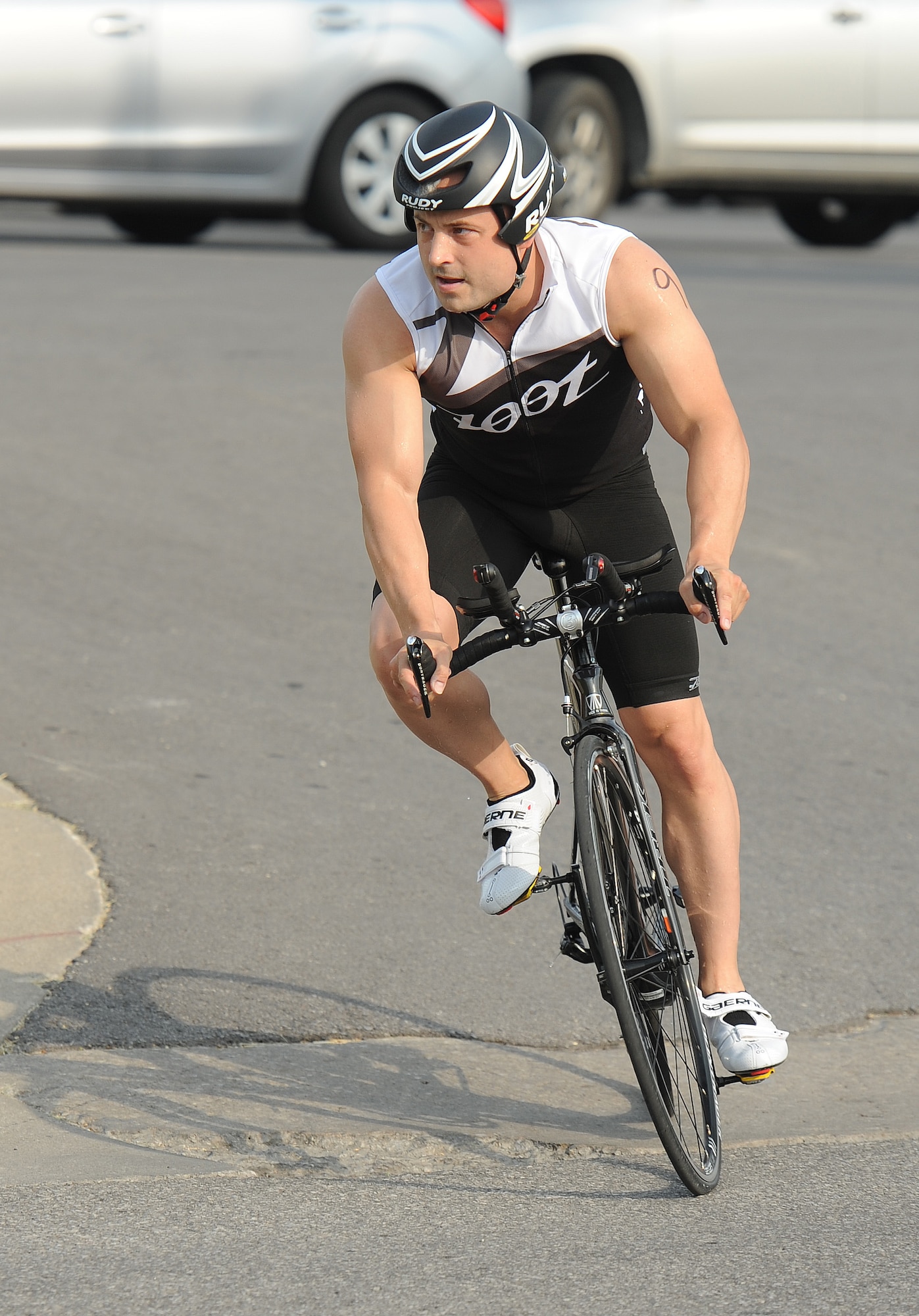 1st Lt. Kevin Knutson, 509th Logistics Readiness Squadron, competes in the cycling portion of a triathlon at Whiteman Air Force Base, Mo., June 21, 2013. This fitness challenge included a 10-kilometer bicycle race, a 420-meter swim and a five-kilometer run. (U.S. Air Force photo by Staff Sgt. Nick Wilson/Released)