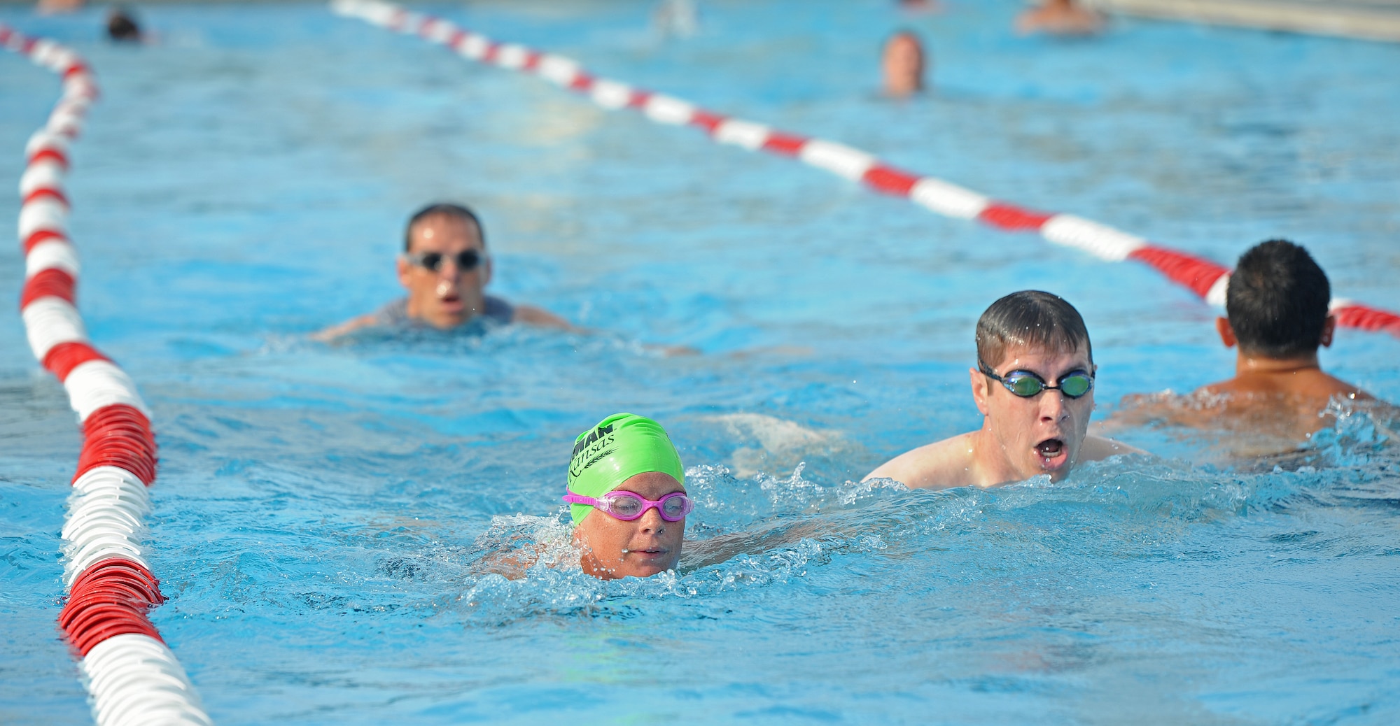 Members of Team Whiteman participate in the 420-meter swim portion of a triathlon at Whiteman Air Force Base, Mo., June 21, 2013. Other events in the triathlon included a 10-kilometer bicycle race and a five-kilometer run. (U.S. Air Force photo by Staff Sgt. Nick Wilson/Released)