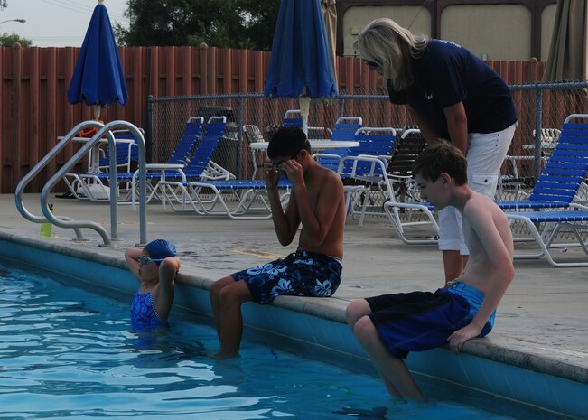Jeanene Graves, 9th Force Support Squadron youth sports and fitness director, coaches the Beale Barracudas swim team during practice at the base pool at Beale Air Force Base, Calif., July 2, 2013. Graves coaches the Barracudas with Jared Nyhart and Alex Dumaplin. (U.S. Air Force photo by Senior Airman Allen Pollard/Released)