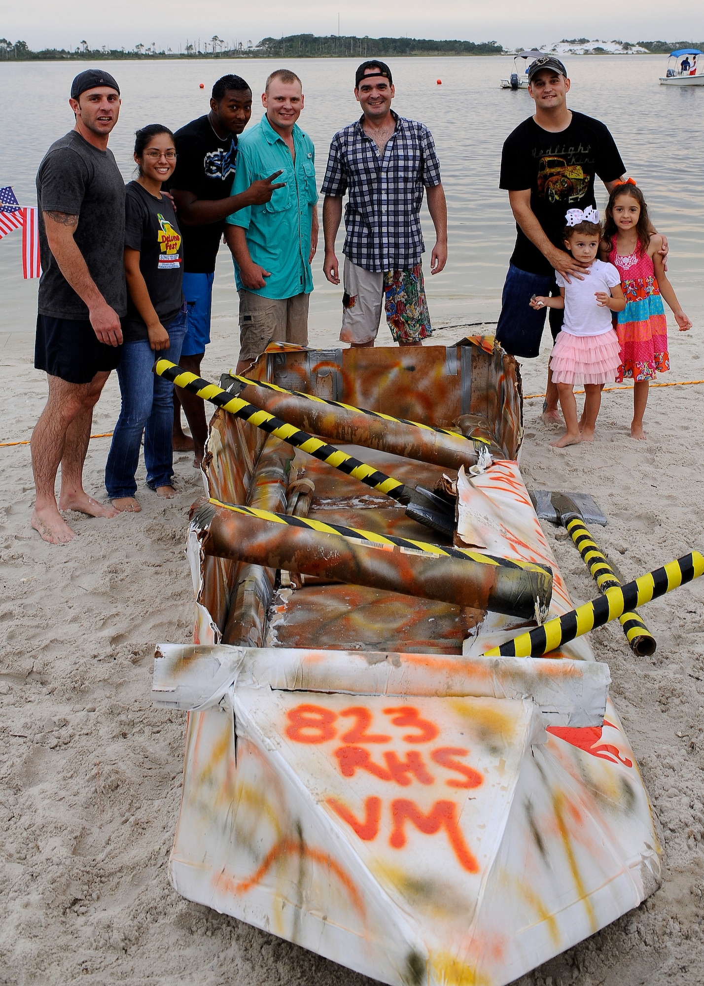 Members of the 823rd RED HORSE pose with their first place winning cardboard boat after winning the race at the Soundside Marina on Hurlburt Field, Fla., June 28, 2013. The 823rd RED HORSE stole the title as the regatta champions from the 1st Special Operations Equipment Maintenance Squadon, the reigning champions. (U.S. Air Force photo by Airman 1st Class Jeffrey Parkinson)