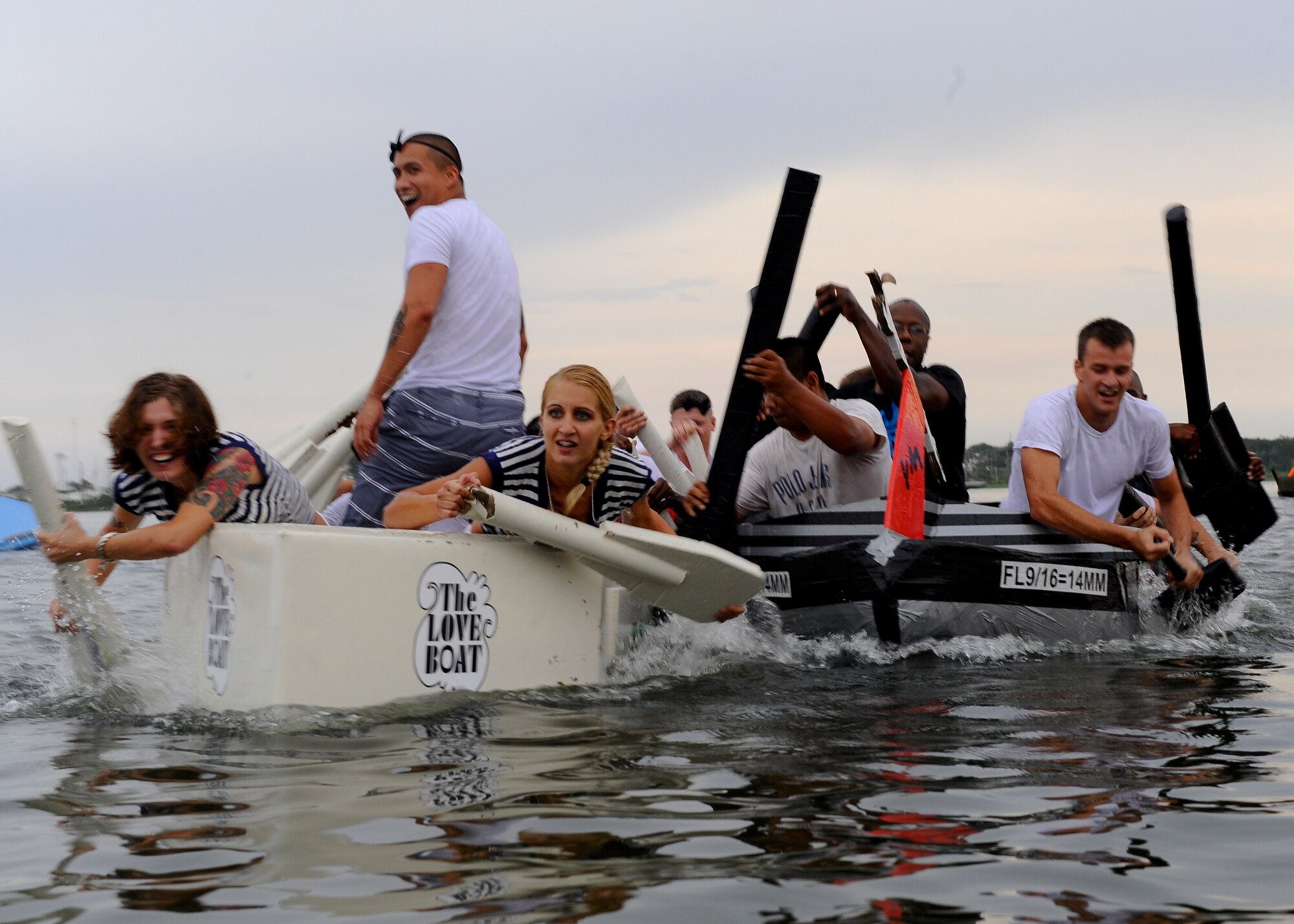 Members from the 1st Special Operations Equipment Maintenance Squadron, left, and the 1st Special Operations Logistics Readiness Squadron battle it out for second place in the 25th annual cardboard boat regatta at the Soundside Marina on Hurlburt Field, Fla., June 28, 2013. The 1st SOEMS, defending champions, settled for second place. (U.S. Air Force photo by Airman 1st Class Jeffrey Parkinson)