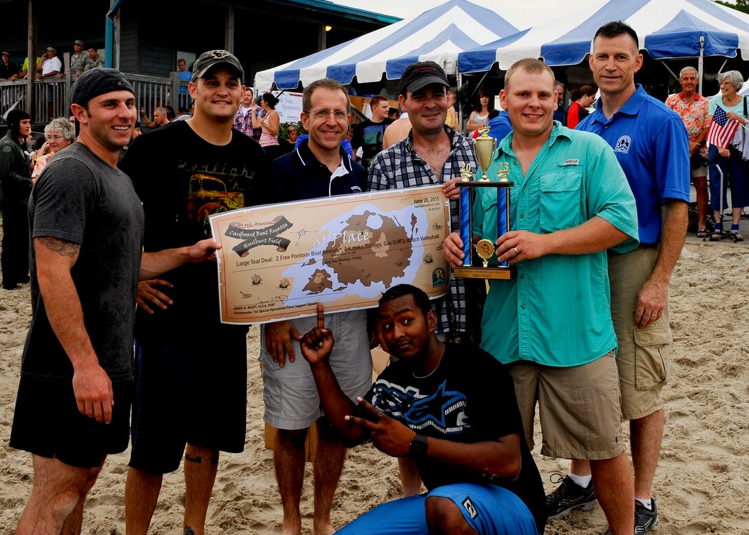 The 823rd RED HORSE is awarded the first place prize by Col. Jim Slife, commander of the 1st Special Operations Wing, at the 25th Annual cardboard boat regatta at the Soundside Marina on Hurlburt Field, Fla., June 28, 2013.  (U.S. Air Force photo by Airman 1st Class Jeffrey Parkinson)
