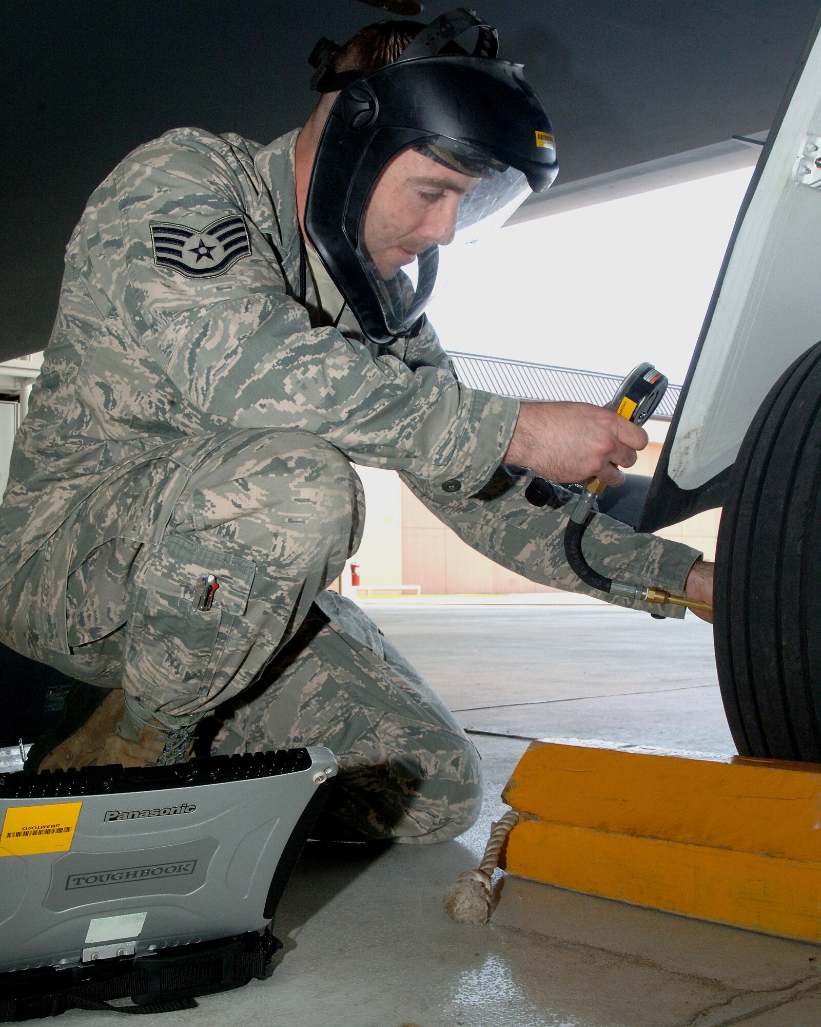 Staff Sgt. Tristan Alvis, 69th Maintenance Squadron, checks the tire pressure of an RQ-4 Global Hawk, July 2, 2013 on Grand Forks Air Force Base, N.D. Alvis was named the Warrior of the Week for the fourth week of June 2013. (U.S. Air Force photo/Airman 1st Class Zachiah Roberson)